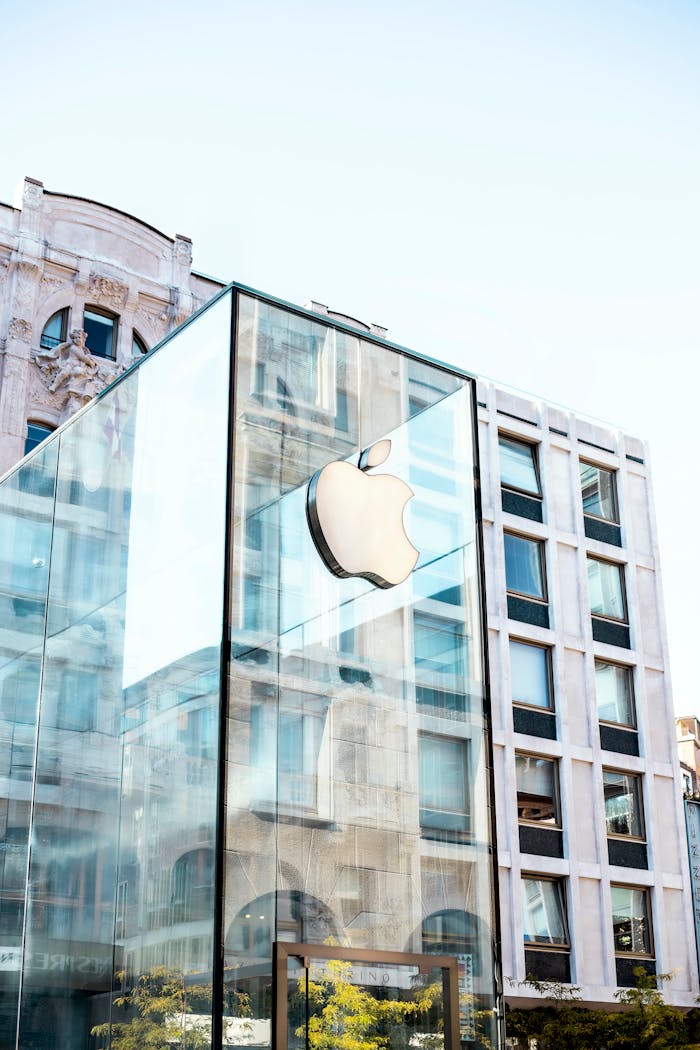 Mastering the First Impression: Your intriguing post title goes here Facade of a modern glass building featuring the iconic Apple logo in Milano, Italy.