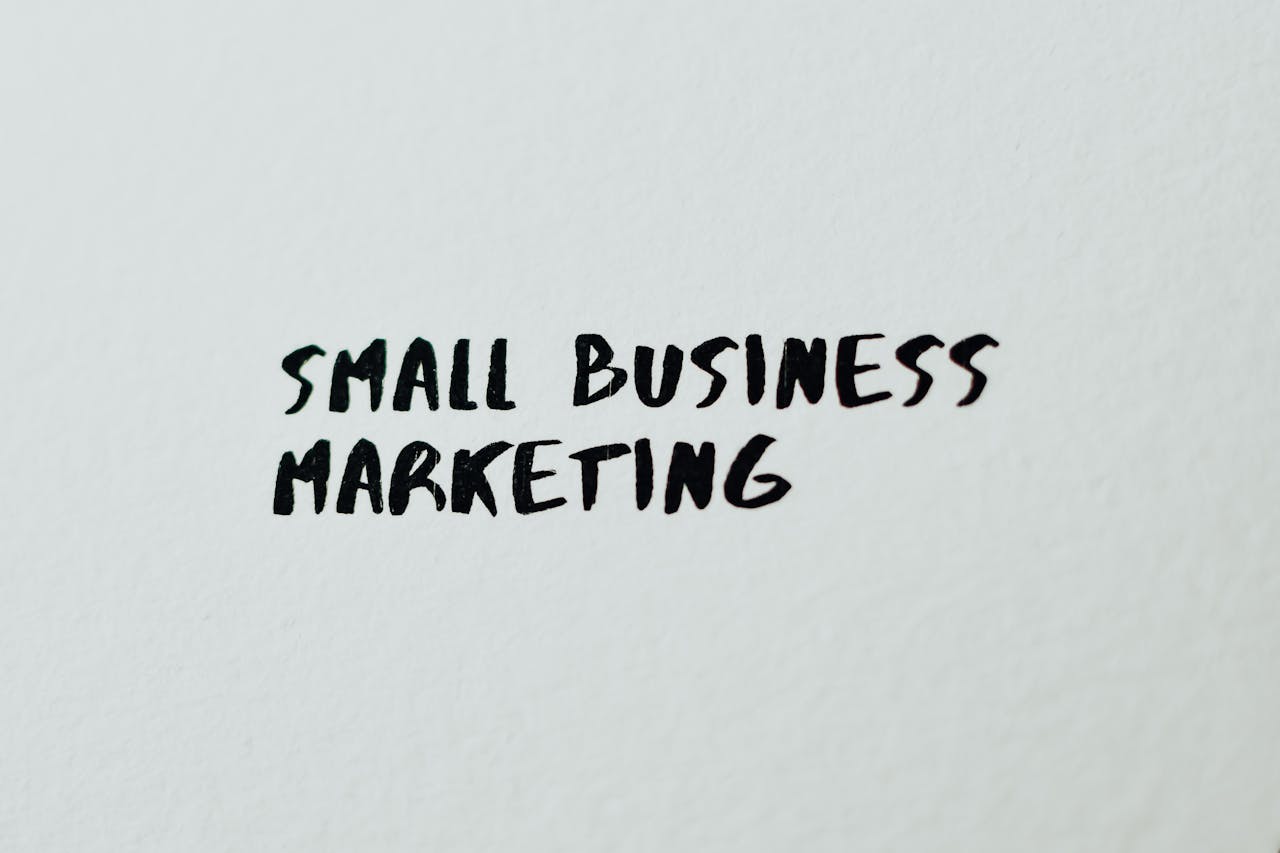 The Art of Drawing Readers In: Your attractive post title goes here Text 'Small Business Marketing' written on white paper for creative use.